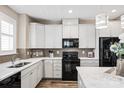 Bright kitchen with white cabinets, stainless steel appliances, and stylish backsplash at 5075 Valita Rd, York, SC 29745