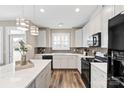 Modern kitchen with white cabinets, an island with bar seating and stainless steel appliances at 5075 Valita Rd, York, SC 29745