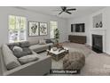 Bright and airy living room featuring a fireplace and modern decor at 5312 Peach Place Ln, Charlotte, NC 28216