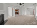 Spacious living area with fireplace, flowing into the kitchen and staircase at 5312 Peach Place Ln, Charlotte, NC 28216