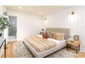 Cozy primary bedroom with neutral tones, accent wall, and ensuite bathroom at 6501 Piney Path Rd, Charlotte, NC 28212