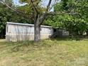 Single-story home surrounded by mature trees and a well-maintained lawn at 6504 Denver Heights Cir, Denver, NC 28037