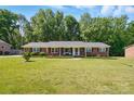 Inviting brick home with well-manicured lawn and landscaping offering great curb appeal at 707 Hester Dr, Dallas, NC 28034