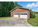 Spacious two-car garage with brick exterior and ample driveway space for parking at 707 Hester Dr, Dallas, NC 28034