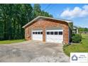 Spacious two-car garage with white doors and a brick exterior, offering ample parking at 707 Hester Dr, Dallas, NC 28034