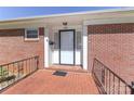 Close up of front porch showing the white door, brick, and black wrought iron at 805 Waverly Pl # 16, Statesville, NC 28677