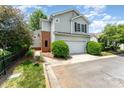 Charming two-story home with a two-car garage, well-manicured landscaping, and brick chimney at 8734 Meadowmont View Dr, Charlotte, NC 28269