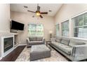 Bright living room featuring high ceilings, a fireplace, and modern furnishings at 8734 Meadowmont View Dr, Charlotte, NC 28269