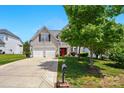 Inviting two-story home featuring a two-car garage, neat landscaping, and long concrete driveway at 8833 Cavonnier Ln, Charlotte, NC 28216