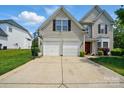 Two-car garage with basketball hoop and long concrete driveway, ideal for multiple cars at 8833 Cavonnier Ln, Charlotte, NC 28216