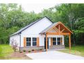 Beautiful exterior of a home with a light brick foundation, dark trim, and a covered front porch at Lot 1 New Pineola Rd, Charlotte, NC 28208