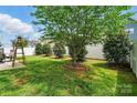 The property features a well-manicured backyard with lush lawn and various trees at 1026 Slew O Gold Ln, Indian Trail, NC 28079