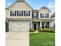 Charming two-story home featuring a two-car garage, well-manicured lawn, and inviting curb appeal at 1026 Slew O Gold Ln, Indian Trail, NC 28079