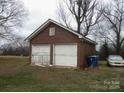 A brick garage with two bays and white doors at 1040 Nc 90 W Hwy, Taylorsville, NC 20681