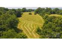 Aerial shot of a large lot showing partially cut grass and trees around its perimeter at 1040 Nc 90 W Hwy, Taylorsville, NC 20681