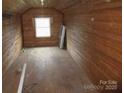 An unfinished room featuring wooden paneled walls and a bright window at 1040 Nc 90 W Hwy, Taylorsville, NC 20681