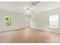 Spacious bedroom with light hardwood floors, a ceiling fan, and natural light from three windows at 1055 Doran Ter, Richburg, SC 29729