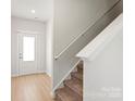 Bright entryway with wood-look floors, a staircase, and a door with glass panels allowing natural light at 1055 Doran Ter, Richburg, SC 29729