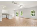 Open floor plan living room with hardwood floors, a ceiling fan, and natural light from the windows at 1055 Doran Ter, Richburg, SC 29729