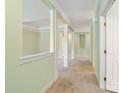 Open-concept living room with decorative columns, neutral carpet, and soft green walls at 1141 Ardwyck Pl, Rock Hill, SC 29730