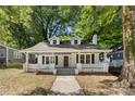 Charming one-story home with dormer windows and a welcoming front porch surrounded by mature trees and ample space at 115 W 5Th Ave, Gastonia, NC 28052
