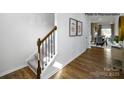 Inviting entryway featuring hardwood floors, a staircase, and view into dining and living areas at 135 Meadow View Dr, Statesville, NC 28677