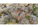 Aerial view of a home nestled amongst trees surrounded by neighborhood at 137 S Penny St, Lancaster, SC 29720