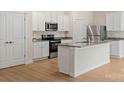 Modern kitchen featuring stainless appliances, granite counters, and white cabinets at 1542 Doran Ter, Richburg, SC 29729