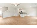 Bright living room showcases open layout with kitchen, light wood floors, and a ceiling fan at 1546 Doran Ter, Richburg, SC 29729
