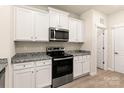 Well-equipped kitchen boasting granite countertops, stainless steel appliances, and ample white cabinetry at 1550 Doran Ter, Richburg, SC 29729