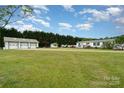 Large detached garage/workshop with multiple bays situated on a spacious lawn, providing ample space for hobbies or storage at 1720 Lowe Dr, Catawba, NC 28609
