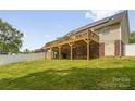 Large backyard features a spacious wooden deck, brick supports and lush green grass at 208 N Kayla Dr, Salisbury, NC 28146