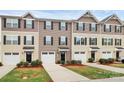 Attractive townhomes featuring a blend of neutral siding colors, shutters, and attached single-car garages at 2635 Mccurdy Trl, Charlotte, NC 28269