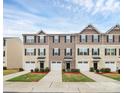 A row of well-maintained townhouses with consistent landscaping and attached garages at 2635 Mccurdy Trl, Charlotte, NC 28269