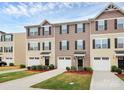 Townhouses with well kept lawns and garages, with a beige and brown color scheme at 2635 Mccurdy Trl, Charlotte, NC 28269
