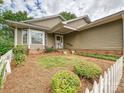 Beautifully landscaped front yard featuring lush greenery and a charming white picket fence at 2919 Peachwood Ct, Fort Mill, SC 29715