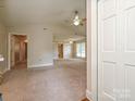 Spacious living room with neutral carpet and high ceilings, perfect for entertaining at 2919 Peachwood Ct, Fort Mill, SC 29715