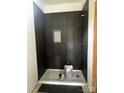 Modern bathroom with a black tile shower and a built in niche for toiletries at 3137 Riber Ln, Claremont, NC 28610