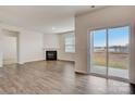 Open-concept living room features a fireplace, sliding glass doors and hard surface flooring at 3662 Charles Nw St, Conover, NC 28613