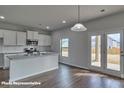 Modern kitchen with granite countertops, stainless steel appliances, a kitchen island, and french doors at 3905 Coleman Dr, Charlotte, NC 28215