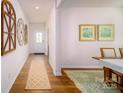 Inviting hallway with decorative accents leading to a bright dining area, showcasing the home's layout at 3948 Ashton Nw Dr, Conover, NC 28613