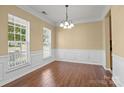 Dining room with hardwood floors, decorative molding, and ample natural light at 4729 Nijinsky Ct, Charlotte, NC 28216
