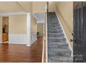 Inviting foyer with hardwood floors, staircase, and elegant white trim at 4729 Nijinsky Ct, Charlotte, NC 28216