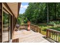 Wooden back deck with sliding glass door access, features a grill and outdoor seating for entertaining at 503 Overbrook Dr, Albemarle, NC 28001