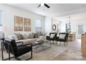 Bright living room featuring stylish seating and an open floor plan leading to the dining area at 5112 Izzo Ln, Charlotte, NC 28214
