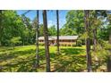 Traditional brick home with lush green lawn and mature trees offering privacy and curb appeal at 6215 Simpson Rd, Charlotte, NC 28216