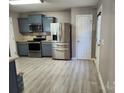 Well lit kitchen featuring stainless steel appliances, blue cabinets, and light countertops at 632 Pawley Dr, Charlotte, NC 28214