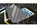 Aerial shot of a backyard with a sparkling pool and an outdoor seating area for entertaining at 67 41St Nw Ave # 3, Hickory, NC 28601
