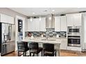 Bright kitchen with stainless appliances, granite countertops, eat-in island, and decorative backsplash at 7017 Treetop Ct, York, SC 29745