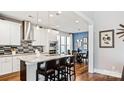 Well-appointed kitchen with stainless appliances, granite countertops, eat-in island, and adjacent dining area at 7017 Treetop Ct, York, SC 29745